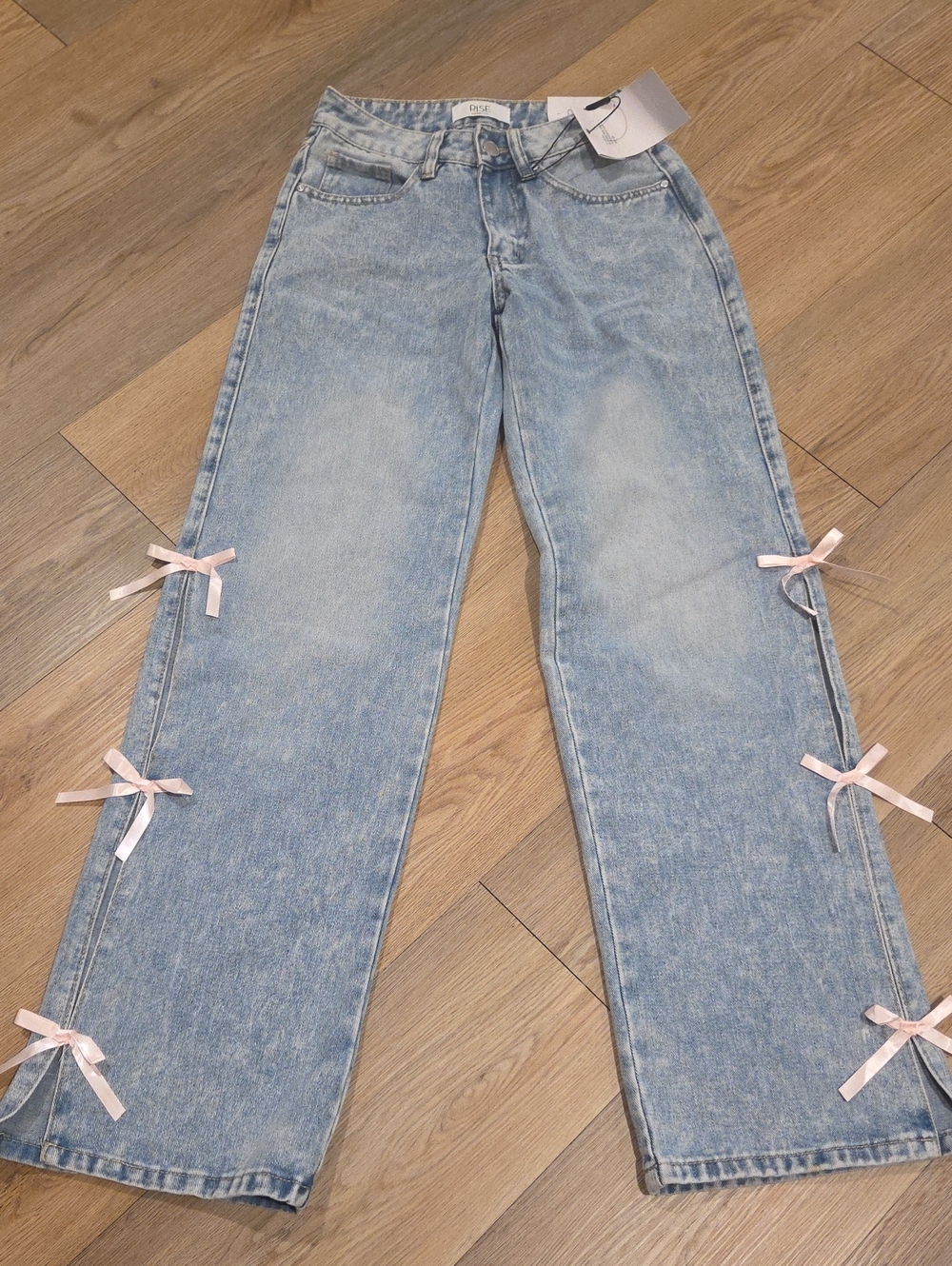 RISE Light Blue Wide-Leg Jeans with Pink Ribbon Accents